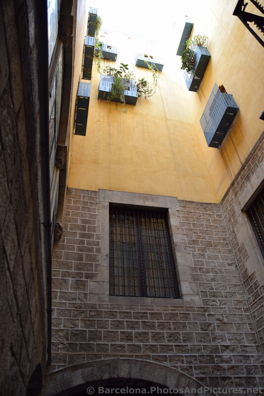 Balconies with Plants hanging above Courtyard of Temple of Augustus.jpg