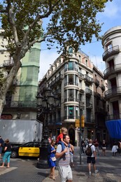 Man Carrying His Toddler Son on Shoulders at La Rambla Barcelona.jpg