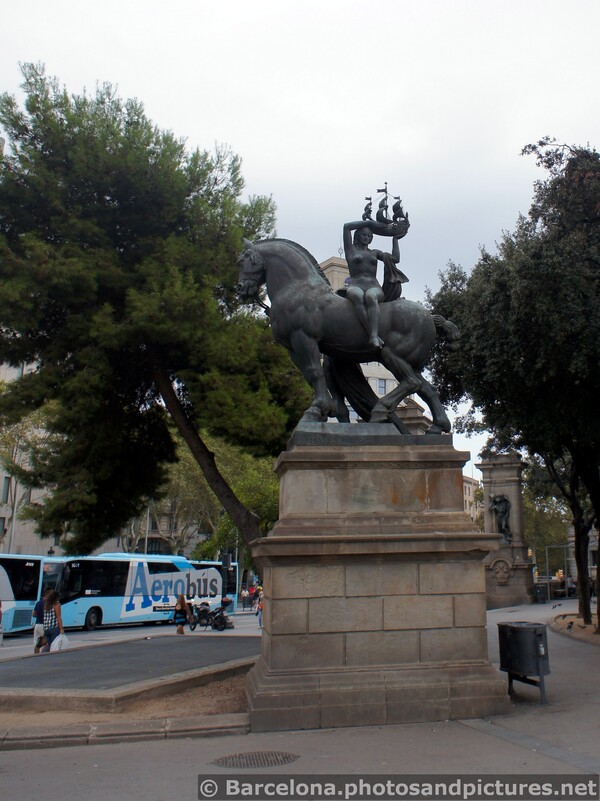 Placa Catalunya Statue of Woman Holding Ship While Sitting on Horse.jpg